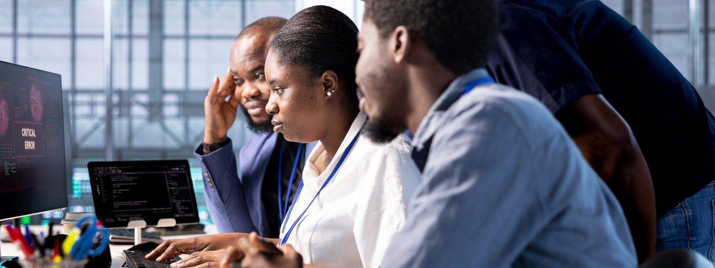 IT team collaborating at workstations